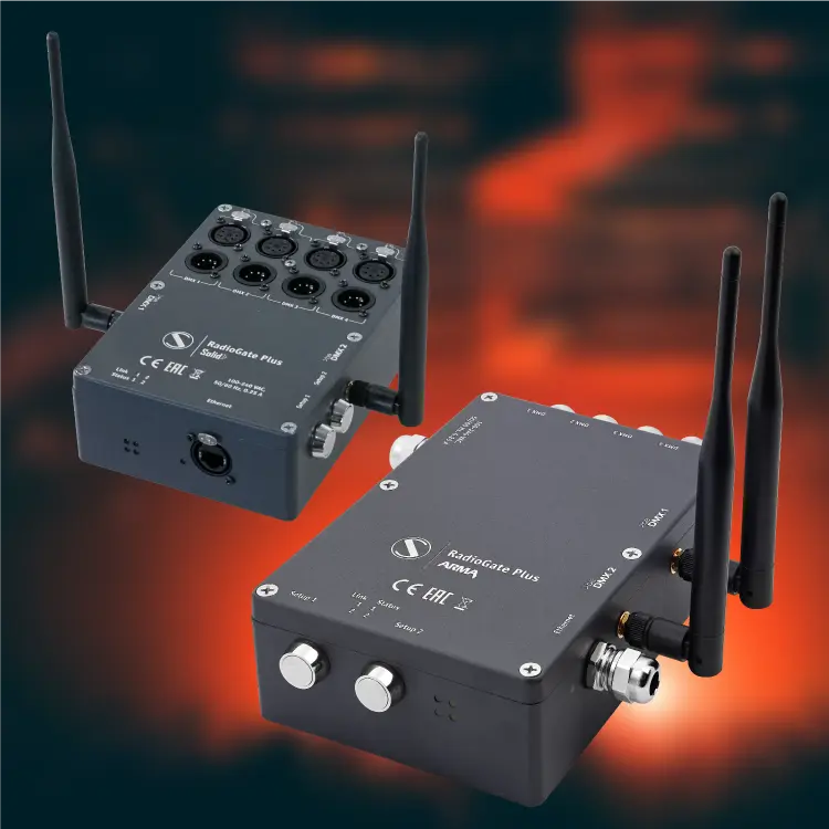 Close-up of a Sundrax RadioGate Plus Arma outdoor wireless DMX/Art-Net gateway device in a rugged gray metal housing with visible status LEDs and connector ports.