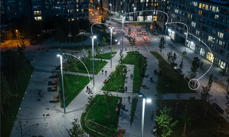 Intelligent street lighting system in modern urban environment Network of smart LED street lights illuminating a city street with integrated sensors and controllers