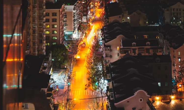 Urban Light Pollution from Above Aerial view of a city skyline glowing under bright streetlights at night