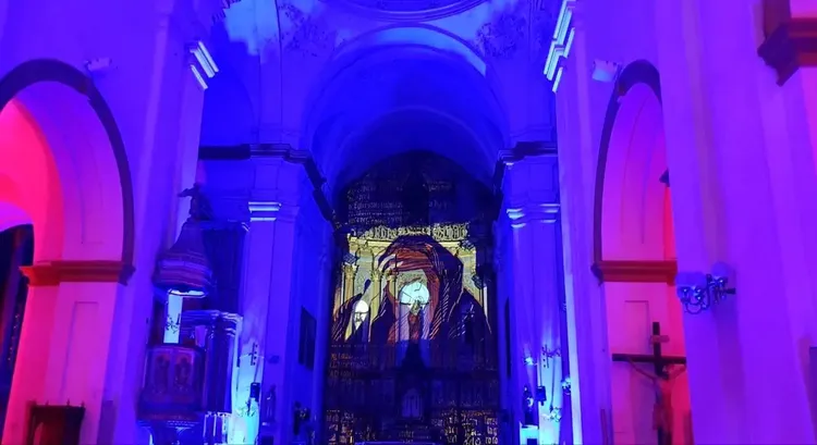 A close-up captures the intense red lighting casting a mysterious and reverent glow, symbolizing spiritual themes in a church setting