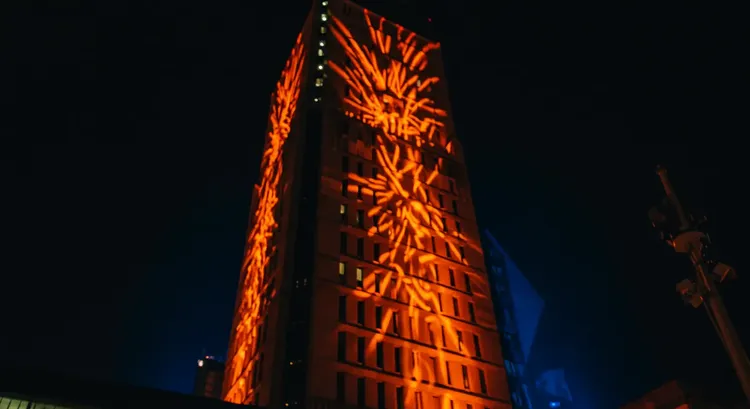Building facade with colorful DMX-controlled lighting at night 