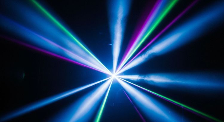 An abstract capture of moving beams symbolizing rhythm, cue transitions, and the choreography of light in time and space.