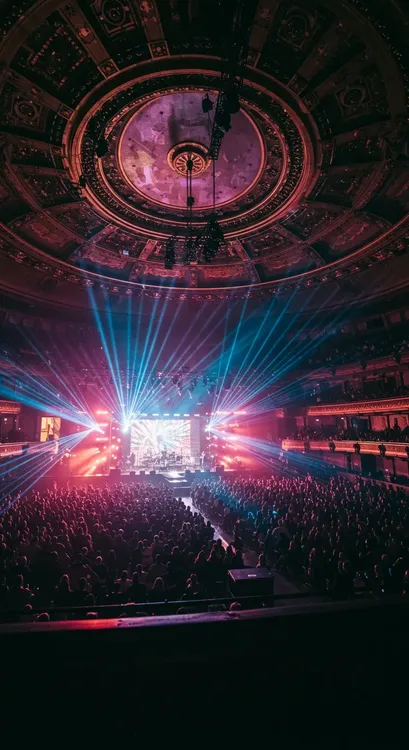 Large concert hall showing complex lighting system with DMX splitters controlling multiple lighting zones, including moving heads and LED walls